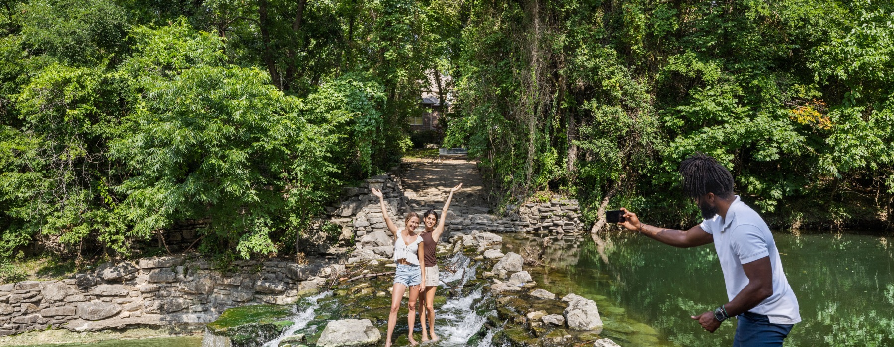 two women having their photo taken in the woods