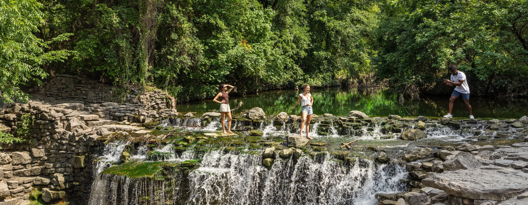 a gorgeous park with a stream of water and a water fall