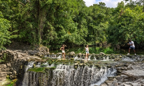 friends taking pictures near water