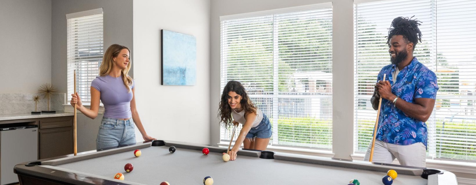 a group of people playing pool