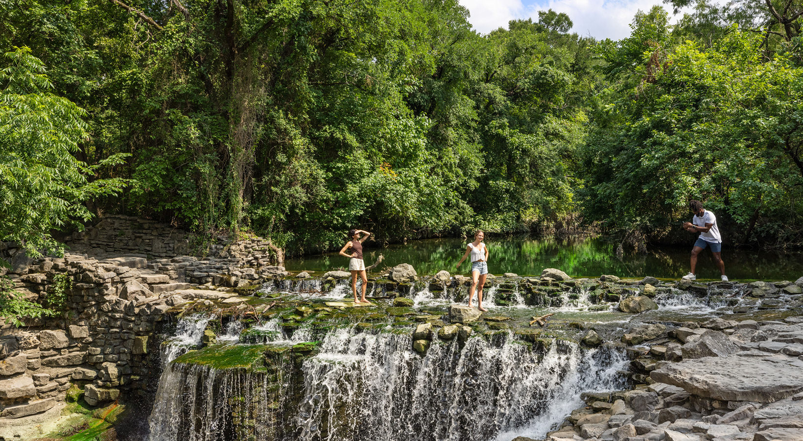 friends taking pictures near water